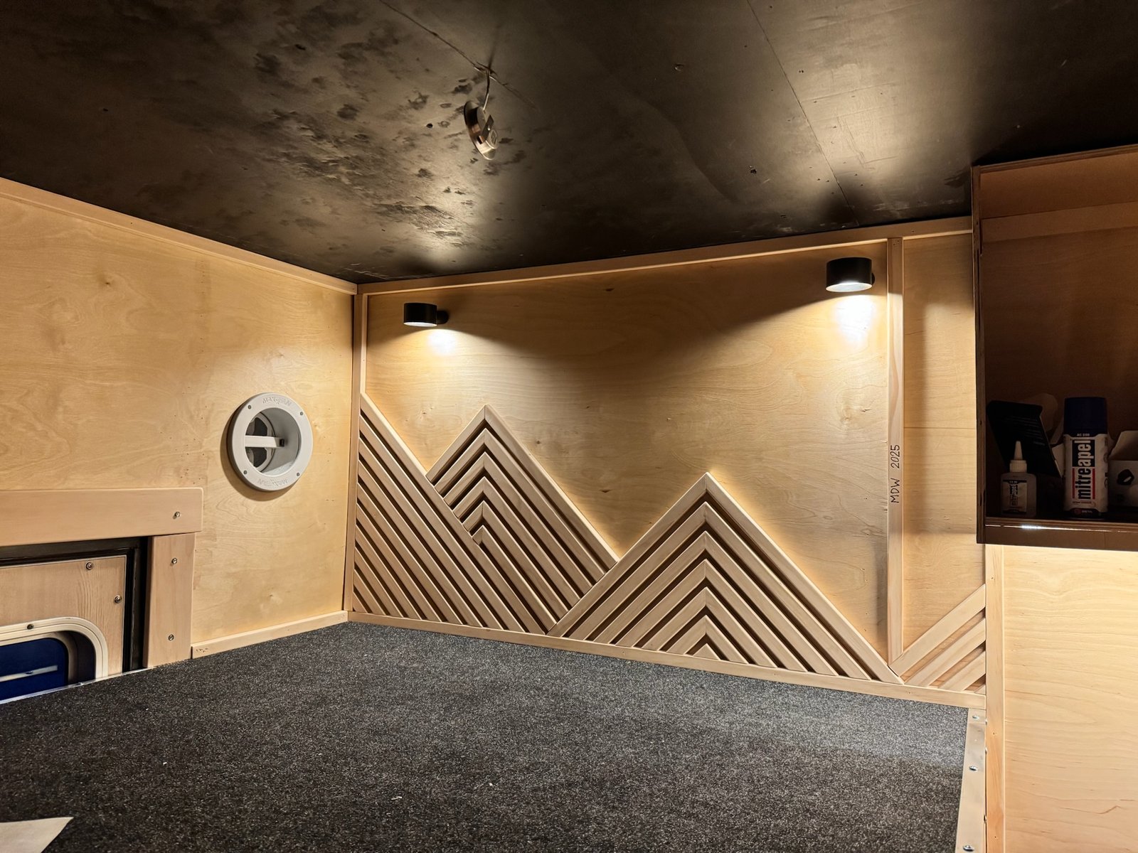 Mountain-inspired wood wall inside the ambulance build